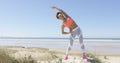 Woman stretching by the sea Royalty Free Stock Photo