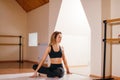 Woman stretching seated spinal twist. Young slim girl makes exercise Royalty Free Stock Photo