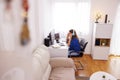 Woman stretching while sitting at her desk in home office