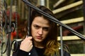 Woman with strict face on stone stairs.