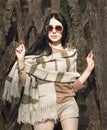Woman in stripe glasses, autumn beige brown clothes. Fashion mod