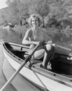 Woman in a striped bathing suit rowing Royalty Free Stock Photo