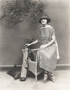 Woman in striped dress with golf clubs