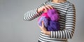 Woman holding some purple and pink balls of wool with copy space