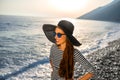 Woman in stripped dress with a hat on the beach Royalty Free Stock Photo