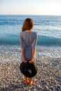 Woman in stripped dress with a hat on the beach Royalty Free Stock Photo