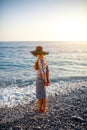 Woman in stripped dress with a hat on the beach Royalty Free Stock Photo