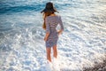 Woman in stripped dress with a hat on the beach Royalty Free Stock Photo