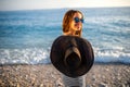 Woman in stripped dress with a hat on the beach Royalty Free Stock Photo