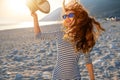 Woman in stripped dress with a hat on the beach Royalty Free Stock Photo