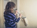 Woman stripping wallpaper Royalty Free Stock Photo