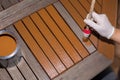 Woman strokes a wooden table with fresh paint