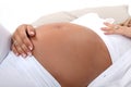 Woman stroking pregnant belly