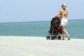 Woman with a stroller on beach