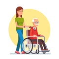 Woman strolling with elder man in wheelchair Royalty Free Stock Photo