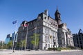 Woman strolling on Notre-Dame Street in Old Montreal on a clear sunny day, with the 19th century city hall in the background Royalty Free Stock Photo