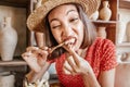 Woman with strong appetite nibbles the bones of a fried chicken leg. The concept of overeating and gluttony and delicious fatty Royalty Free Stock Photo