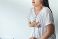 Woman with strong chest pain and hands touching her chest,Heart attack symptom Royalty Free Stock Photo