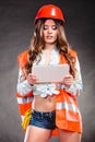 Woman structural engineer with tablet working.