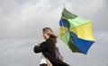 Woman struggling to hold her umbrella on a windy day Royalty Free Stock Photo