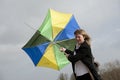 Woman struggling to hold her umbrella on a windy day Royalty Free Stock Photo