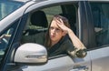 Woman stuck in a traffic jam feeling stressed