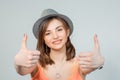 Woman student being excited giving thumbs up on grey Royalty Free Stock Photo