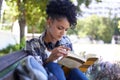 Woman, student and reading on bench with book for university study, learn education or relax. Female person, academic Royalty Free Stock Photo