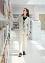 Woman, student and search in library for book choice, knowledge or learning at bookstore for education. Female looking Royalty Free Stock Photo
