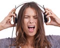 Woman in studio with headphones, noise and scream in pain with feedback, sound or audio. Face of angry girl listening to Royalty Free Stock Photo