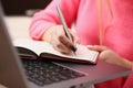 Woman study hard write down information to notebook