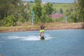 Woman study wakeboarding on a blue lake Royalty Free Stock Photo