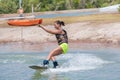Woman study wakeboarding on a blue lake Royalty Free Stock Photo