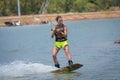 Woman study wakeboarding on a blue lake Royalty Free Stock Photo