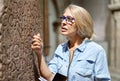 Woman studying ancient writing hieroglyphs at museum.