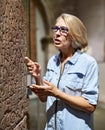 Woman studying ancient writing hieroglyphs at museum of arts