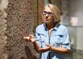 Woman studying ancient writing hieroglyphs at museum of arts