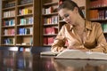 Woman Studying At Desk In Library Royalty Free Stock Photo