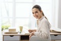 Woman studying at home and smiling