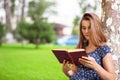 Woman studying reading a book while sitting in campus Royalty Free Stock Photo