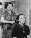 Woman styling another womans hair Royalty Free Stock Photo