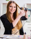 Woman styling her hair with hairdryer Royalty Free Stock Photo