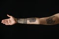 Woman with stylish tattoos on arm against background, closeup Royalty Free Stock Photo