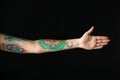 Woman with stylish tattoos on arm against background, closeup Royalty Free Stock Photo