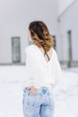 Woman stylishly dressed jeans sweater snow winter