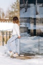 Woman stylishly dressed jeans sweater snow winter