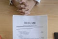 Woman submits job application, Interviewer reading a resume.