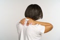 Woman suffer from neckpain after long office work at computer, massage neck to relief muscle strain