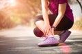 Woman suffering from an ankle injury while exercising. Running sport injury concept