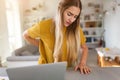 Woman suffering backache while using laptop